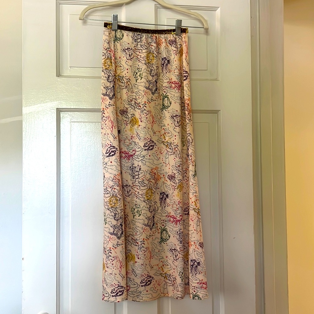 Astrological skirt around mid length with gold textured belt line. Colorful.